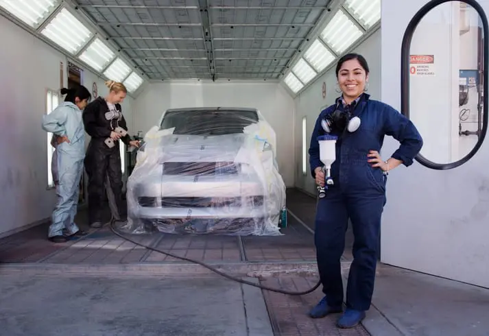 Carolina Collision and Frame Service | Auto paint technicians inspecting fresh paint on a car in a paint booth