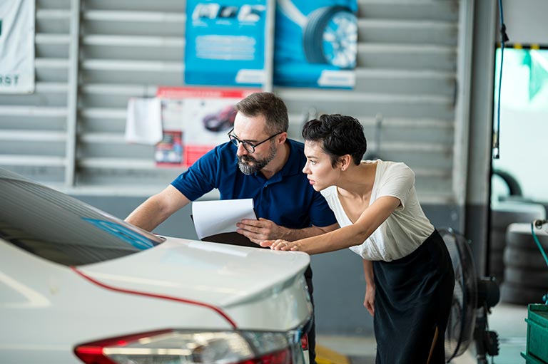 Technician consults client at repair shop