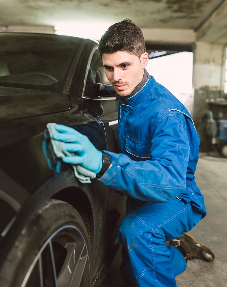 Mechanic polishing black car