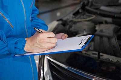 Mechanic inspecting car engine